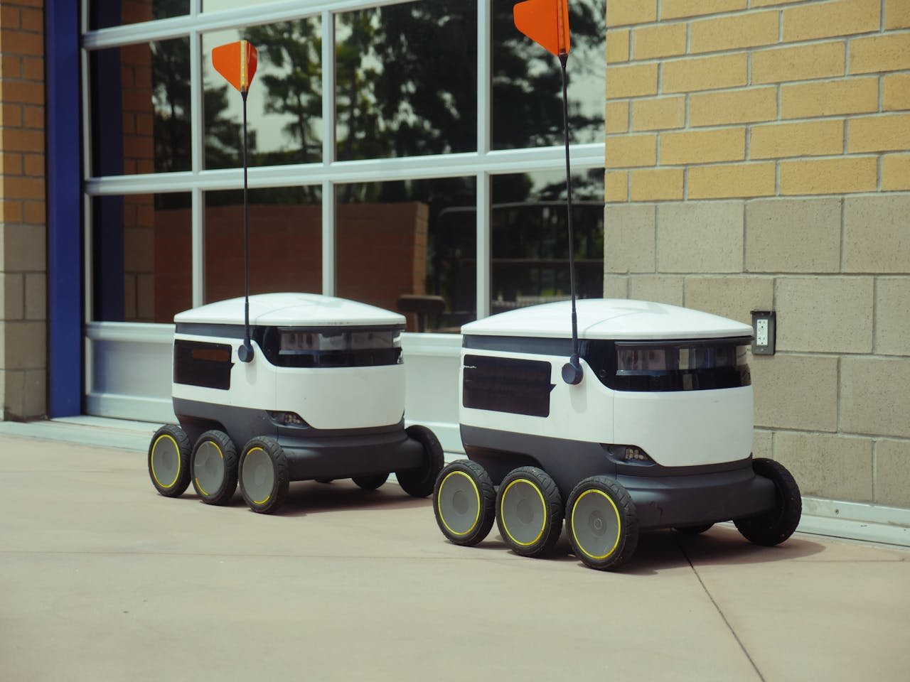 Futuristic autonomous robots designed for efficient outdoor food delivery.